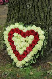 Sympathy flowers are a comforting reminder to the bereaved that we share in their grief and add warmth to the services. Red And White Heart Shaped Sympathy Flowers Or Funeral Flowers Near A Tree Stock Photo Picture And Royalty Free Image Image 133137646