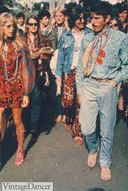 Exaggerated bell bottom pants with a big belt and satin shirt was one classic 70s look. Hippies In The 60s Fashion Festivals Flower Power