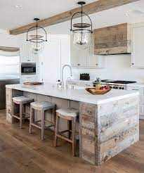The rustic white shiplap accent wall contributes to the horizontal patterns found throughout the kitchen: Reclaimed Plank Shiplap Kitchen Island Reclaimed Plank Shiplap Kitchen Hood The Kitchen Combines Rustic Farmhouse Kitchen Rustic Kitchen Kitchen Island Design