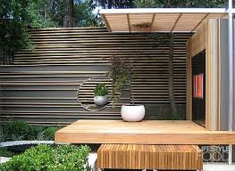 The entire fence of this backyard is made of bamboo in the natural brown finish which looks so enchanting. I Need A Garden Designed By Brendan Moar Dryspellgardening Brendanmoar Beautiful Gardens Bamboo Fence Backyard Privacy Fence Design