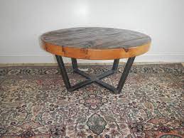 Pieces of reclaimed wood form a richly grained mosaic on this coffee table. Custom Made Reclaimed Wood And Welded Steel Round Coffee Table By Don Yacovella Custommade Com