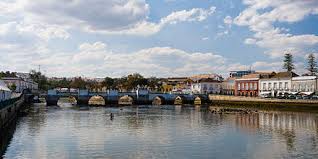 The restaurant's interior features a spacious, open dining room with warm colors and white linen tablecloths over round tables. Tavira Wikiwand