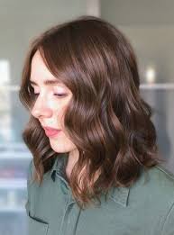 This gorgeous bob has been parted to the side, and finished with an asymmetrical style, longer at the front and long thick bob hairstyle for women. Wavy Bob Haircut