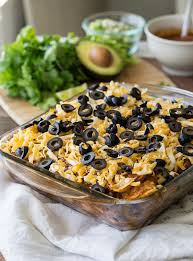 Make the next layer by arranging four pieces of flour tortilla on top of the enchilada sauce. Chicken Enchilada Casserole Recipe I Wash You Dry
