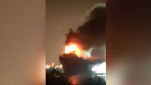 Old aircraft carrier, once part of mighty Soviet fleet, burns in Chinese lagoon