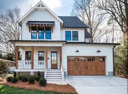 Black And White House With Wood Garage Door Modern Farmhouse Style On Point Love Just About Everything Going On Here Inspiration From Exteri Modern Farmhouse Exterior House Exterior Farmhouse Exterior