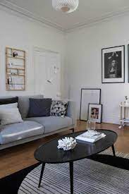 Scandinavian Style Living Room With Grey Sofa Black Coffee Table White Walls And A Warm Oak Living Room Grey White Furniture Living Room Couches Living Room