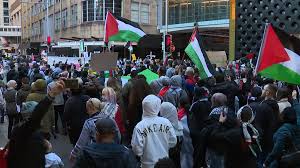 As israeli's occupation of palestine violently escalates, thousands of people rallied at protests around the country to stand in solidarity with palestinians on the anniversary of nakba. Palestine Rally Attendee In Sydney Slammed For Mock Israeli Flag Bearing Nazi Swastika 7news