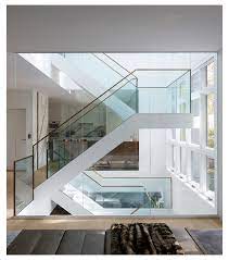 Amuneal Custom Marble Glass Stair In Open Light Well Glass Stair Case Glassstaircase In 2021 Glass Staircase Glass Staircase Railing Staircase Design Modern