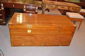 This rare, massive coffee table features a heavy glass top of 20mm, brass plated legs, and a leatherette plated side with brass accents. Antique Military Camphorwood Trunk Coffer Coffee Table Ref No 03133