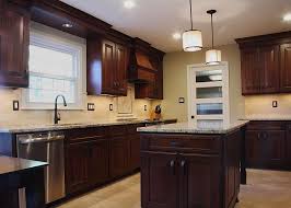 This Kitchen Remodel Included Dark Brown Wooden Cabinets Paired With Neutral Granite Countertops And A Neutra Kitchen Remodel Wooden Cabinets Spacious Kitchens