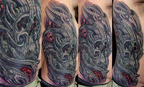 Right hand grey ink skull tattoo on hand. Biomechanical Skull Cover Up Terry Ribera