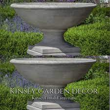 A selection of three concrete planter urns. Cast Stone Urn Planters Kinsey Garden Decor