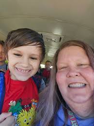 School bus driver washing vehicle and sharing experience