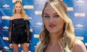 Candice Swanepoel shows off lithe pins in sheer black playsuit while  appearing