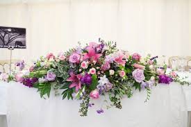 The grange is an elegant wedding venue with a 'hamptons style' sense of grandeur combined with warm hospitality. A Farm Wedding In Essex Wedding Top Table Flowers Wedding Reception Flower Arrangements Table Flower Arrangements