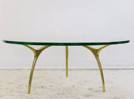 These tables, inspired by the forms of contemporary art and fashion, represent the thinking of leading italian designers, and are rendered in various materials in exotic woods, marble, onyx, glass and leather. Coffee Table In Glass And Polished Brass By Belgian Designer Kouloufi 1970s 105158