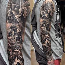 A black and gray sleeve with a prominent knife and portrait of a woman is featured in this photo. Tattoo Sleeve Ideas For Men Black And Grey Ink Black And Grey Tattoos Sleeve Skull Sleeve Tattoos Sleeve Tattoos