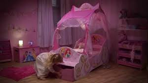 Finished with two attached guardrails to help keep your little one from falling out of bed while sleeping, the disney princess canopy toddler bed by delta children provides the independence your child is seeking, while keeping them safe all night long. Disney Princess Carriage Toddler Bed With Storage Opener Youtube