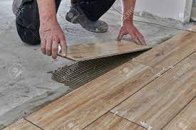 Maybe you would like to learn more about one of these? Hands Of The Tiler Are Laying The Ceramic Wood Effect Tiles On The Floor Stock Photo Picture And Royalty Free Image Image 120544067