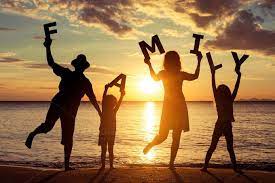 Happy Family Standing On The Beach Family Beach Pictures Beach Family Photos Family Picture Poses