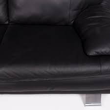 Features a camelback and flared arms over bun feet. Italsofa Leather Sofa Black Two Seat Couch At 1stdibs