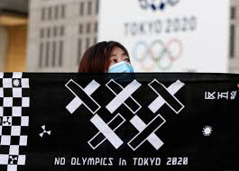 People pass an advert for the tokyo 2020 olympics on march 25, 2020 in tokyo, japan. Japan S Suga Insists Delayed Tokyo Olympics Will Go Ahead In 2021 Coronavirus Pandemic News Al Jazeera