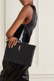 This luxurious brand features great leather bags and jackets, that pair perfectly with their accessories, including trendy sunglasses. Black Monogram Quilted Leather Pouch Saint Laurent Net A Porter