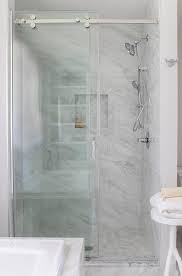 This giant walk in shower centered primary bath will send you soaring to the top of a luxury resort penthouse suite. Walk In Shower With Glass Shower Doors On Rails Transitional Bathroom
