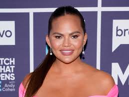 Chrissy Teigen shows off hip-length 70's waves