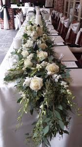 Georgeous Seeded Eucalyptus Runner For The Head Table With White Dendrobium Orchids White Ros White Roses Wedding White Rose Centerpieces Head Table Wedding
