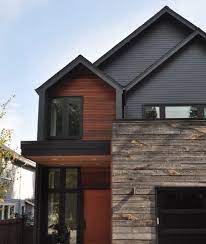 The house is anchored to the land by stone retaining walls made entirely of granite taken from the site during construction. Wood Siding Accent Wall Exterior Novocom Top