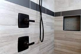 Gray bathroom ideas using gray tiles are perfect for designing a neutral bathroom space that men and women can both enjoy equally. Beige Tiled Shower With Black Tile Accent Strip And Gray Tile Accent Niche Shower Tile Bathroom Remodel Shower Bathroom Shower Tile