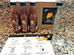 Instruction booklet, sanitizer/cleanser, gloves, customizable labels, 3 bottles with lids and dashers, funnel, apple cider vinegar, white distilled vinegar, guajillo peppers, chipotle peppers, arbol peppers, cayenne powder, ancho powder, curry. Sauce Lab Hot Sauce Making Kit Review