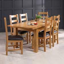Extending solid oak dining table and 6 chairs, in near perfect condition, the fire retardent labels are still attached to the chairs! Solid Oak Medium Extending Dining Table 6 Ladder Back Chair Set The Furniture Market