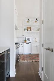 The floor and cabinets provide most of the color in the kitchen, and they combine with the walls and ceiling to create a space that can be relaxing, sumptuous or conducive to work. Brown Oak Floors With White Shaker Cabinets Transitional Kitchen
