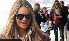 Makeup free Elle Macpherson jets out of Sydney with son