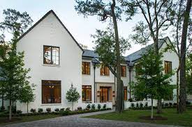 White board and batten modern farmhouse with a black roof, wood beams, and brick steps. White Brick With Black Accents House Exterior Modern Farmhouse Exterior Architecture