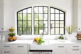 For the kitchen of a vacation house in portland, ore., designer michelle ruber of encircle this is a fun, creative way to honor your friends and family with a giant photograph as your backsplash. Three Arch Casement Windows Over Farmhouse Sink Transitional Kitchen