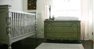 A Silver Gray Baby Crib And Olive Green Dresser In A Nursery With Mint Green Walls Baby Nursery Decor Green Baby Nursery Modern Baby Nursery