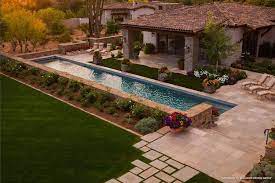 This is a more traditional setting and while the tile may not be directly exposed to the elements of water and sunlight, it will hold up beautifully to wind and foot traffic. Travertine Pavers Through Grass Pattern And Shape Garden Design Paradise Valley House Design