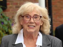 The late Anna Karen who played Olive in 'On the Buses' holding up the board  game based