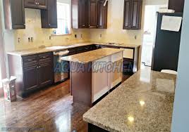 It is set off by wood floors that flow throughout the kitchen and ties the connecting living areas together. Giallo Ornamental Granite For Warm Elegant Kitchen Design