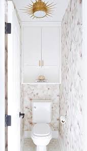 Craft an amazing feeling in any bathroom similar to this modern & contemporary design from dotted line. Feminine Water Closet Design With Brass Sunburst Flush Mount Light Transitional Bathroom