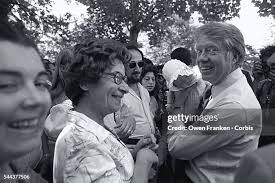 Presidential candidate Jimmy Carter holds an infant surrounded by... News  Photo
