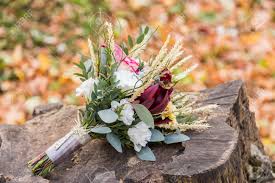 Greenery in a wedding bouquet is also a symbol of nature and new beginnings. Beautiful Wedding Bouquet On The Stump With Fall Foliage Stock Photo Picture And Royalty Free Image Image 59723345