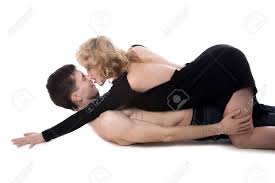 Beautiful Young Woman Taking The Lead In Love Play, Couple Before Sex Lying  Down On The Floor, Steamy Scene After Party, Studio, White Background  Фотография, картинки, изображения и сток-фотография без роялти. Image