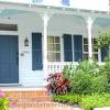 White house blue shutters yellow door. 1