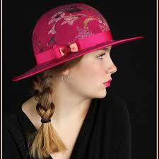 Two gossamer hats getting attention to finish them up