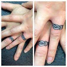 50 Romantic Ring Tattoo Designs To Immortalize Your Love Wedding Ring Finger Tattoos Ring Tattoo Designs Wedding Band Tattoo